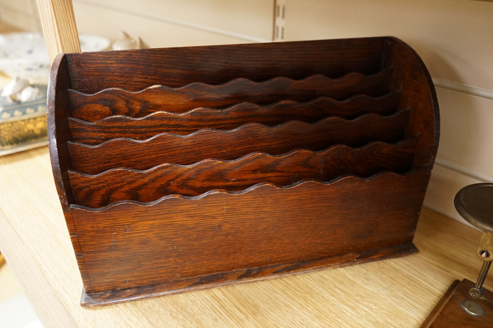 A tooled leather writing slope, a letter rack and postage scales, largest 37cm wide